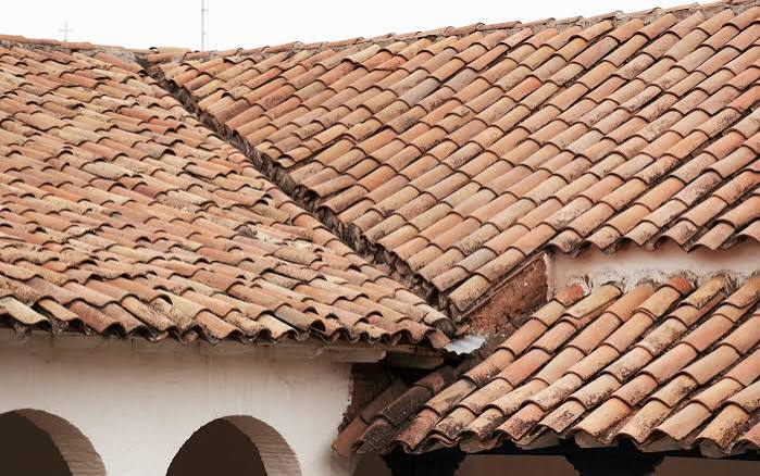 Aged clay tile roof with weathered and uneven tiles