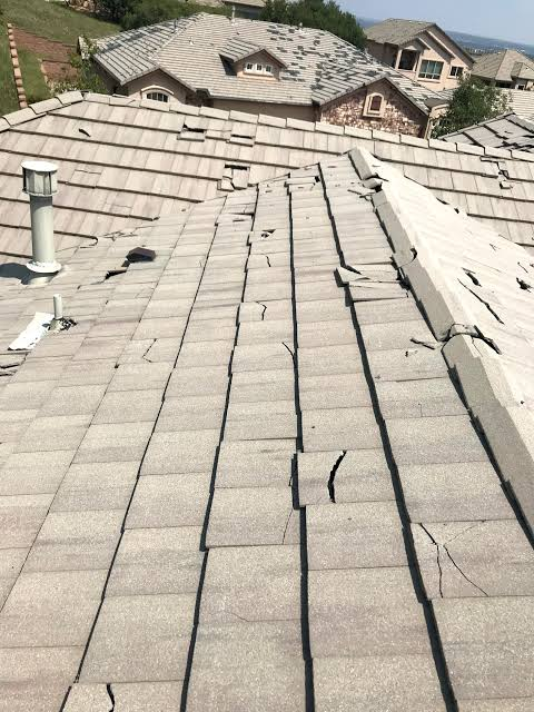 Composite roof tiles showing widespread cracking and breakage