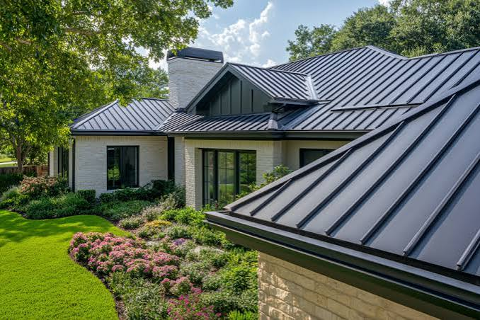 Dark standing-seam metal roof on a landscaped residential home