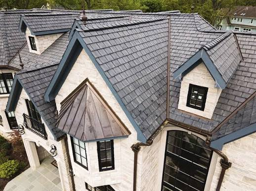 Complex architectural home finished with gray slate roofing