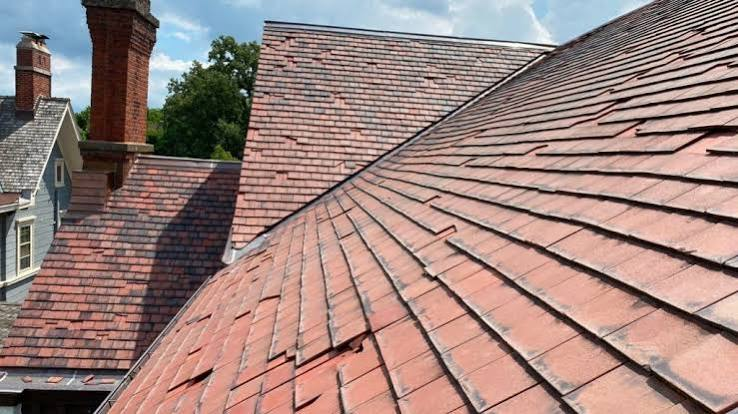 Weathered multicolor slate roof with intersecting slopes