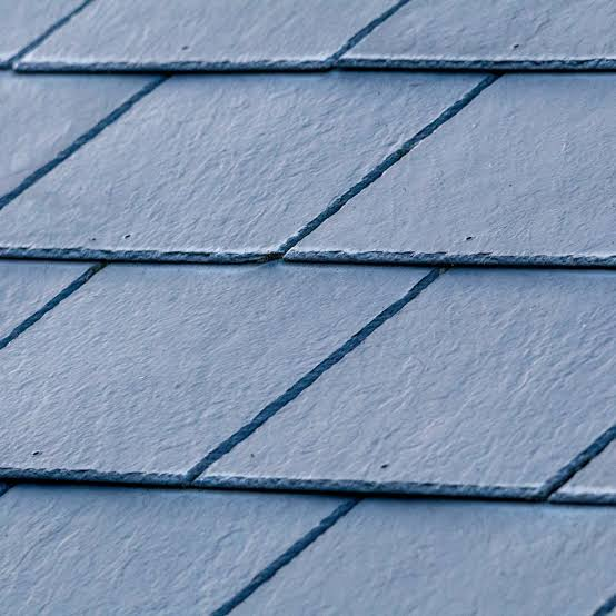 Close view of blue-gray synthetic slate-style roof tiles