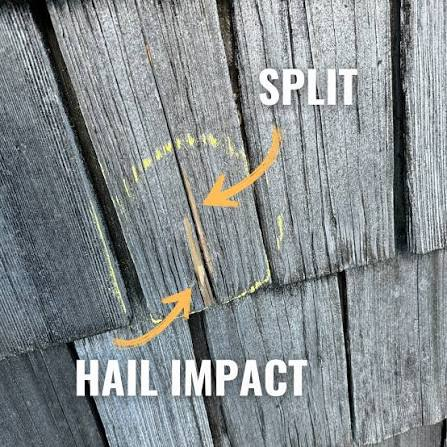 Hail impact and split marked on a weathered wood shake